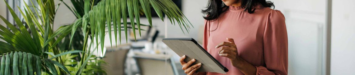 women in an office using a tablet